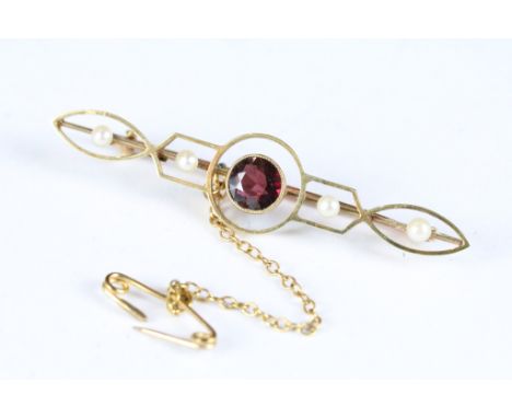 An early 20th century Art Nouveau 15ct gold bar brooch with amethyst and seed pearl decoration. 