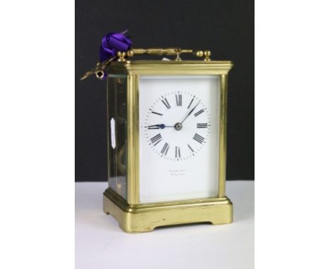 A brass cased carriage clock with bevelled glass panels, retail marked for Joseph Gacph of Gibraltar, complete with key. 