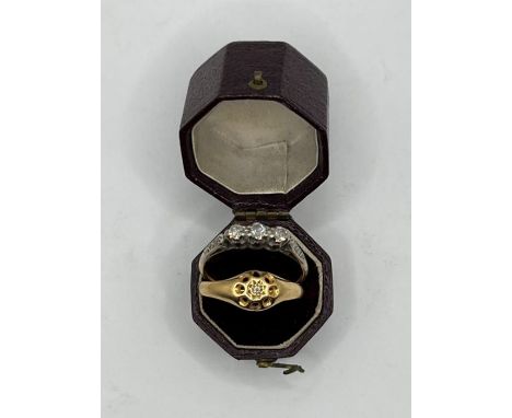 An 18ct gold three stone diamond ring (one chipped) with three eight cut diamonds to each shoulder, shank stamped 18ct. Appro
