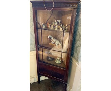 A Chippendale style mahogany corner glazed cabinet, moulded cornice over a foliage lattice fretwork, above a single glazed do