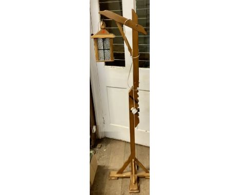 A 20th century blonde oak carved adjustable standing lamp, in manner of a street lamp. 168cm H