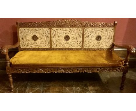 An Indonesian oak bergere living room suite three seater sofa with three matching armchairs, two side tables and coffee table