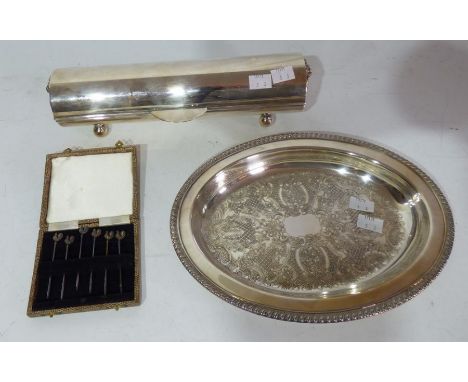 A plated cylindrical box with hinged cover with lion's mask and ring handles on four ball feet a set of six silver cocktail s