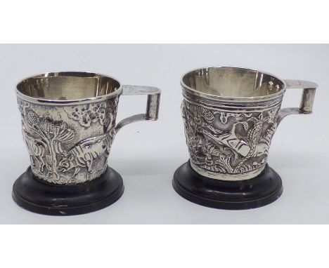 Pair Greek silver cups , moulded with a man and bulls and a farmer being trampled by bulls .6.5cm high , stamped 900 and 8.72