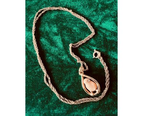 Yellow metal rope style chain, 56 cms in length, with a pendant styled as an enamel chick in egg shaped outline. The pendant 