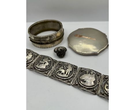 A selection of silver jewellery comprising a poison ring, with a putti design, hallmarked London, 1967. Size M; A sterling si