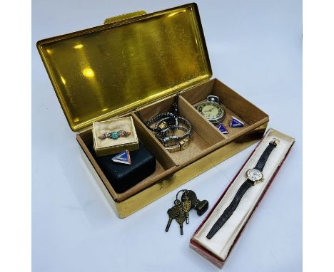 Brass box containing five ladies wrist watches; an Ingersoll triumph pocketwatch on a brass Albert; 3 x V-victory enamel badg