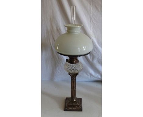 An oil lamp , on Corinthian column silver plated base, having opaline shade and clear chimney, approx. overall height 63cmThe
