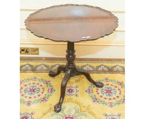 ***AWAY***

A Victorian mahogany tilt-top tripod table, raised pie crusted top, raised on a turned column, foliate carved leg