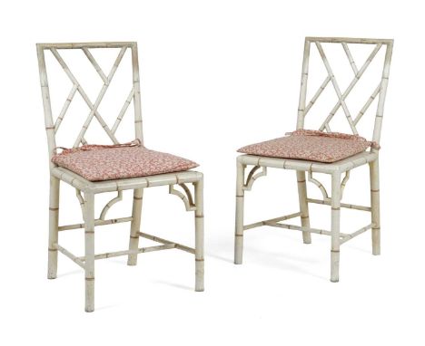 A PAIR OF PAINTED FAUX BAMBOO COCKPEN SIDE CHAIRS IN GEORGE III STYLE, 20TH CENTURYeach with a drop-in cane seat and a squab 