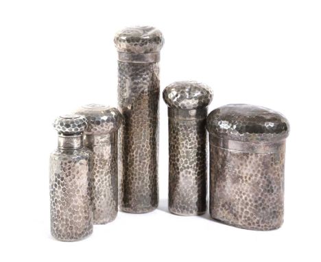 A SET OF FIVE LATE VICTORIAN SILVER TOILET JARSBY CHARLES DUMENIL, LONDON 1896 AND 1897 with spot hammered decoration, initia