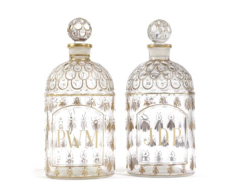 A PAIR OF FRENCH GLASS EAU DE COLOGNE BOTTLES AND STOPPERSBY GUERLAIN, 20TH CENTURYeach decorated in gilt with scales and bee