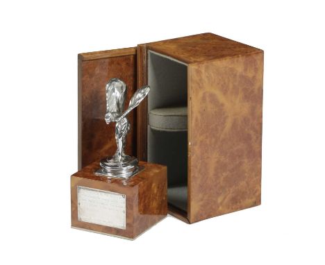 A ROLLS ROYCE SPIRIT OF ECSTASY PRESENTATION CAR MASCOTC.1971on a burr walnut plinth, with a white metal plaque inscribed 'Pr