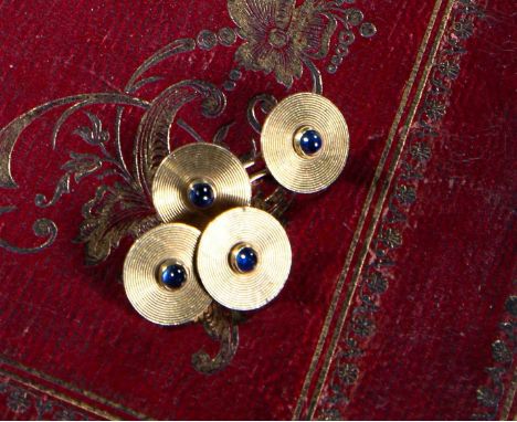 A PAIR OF SAPPHIRE AND GOLD CUFFLINKSBY CARTIEReach disc set with a cabochon sapphire within engine-turned concentric circula