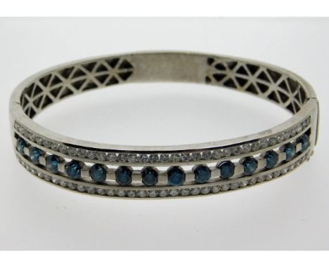 A 14ct white gold bangle set with 7.25ct of blue &amp; white diamonds, white diamonds are G colour, SI-1 clarity, internal di