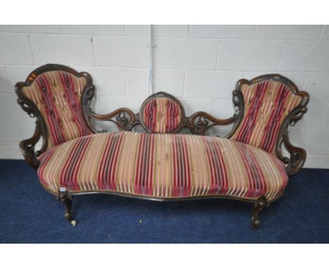 A VICTORIAN WALNUT SOFA, with a double crown back, open foliate decoration and circular centre, on cabriole legs, length 196c