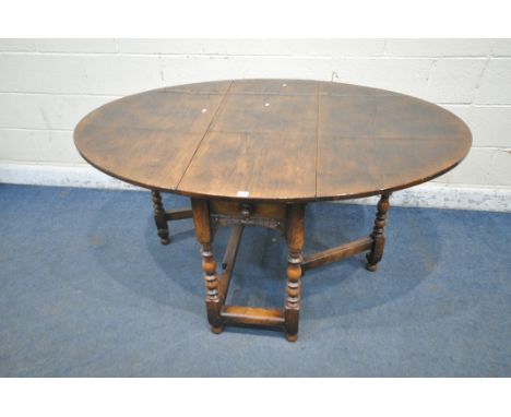 POSSIBLY TITCHMARSH AND GOODWIN, A GOOD QUALITY SOLID OAK GATE LEG TABLE, with a drawer to one end, and a dummy drawer to the