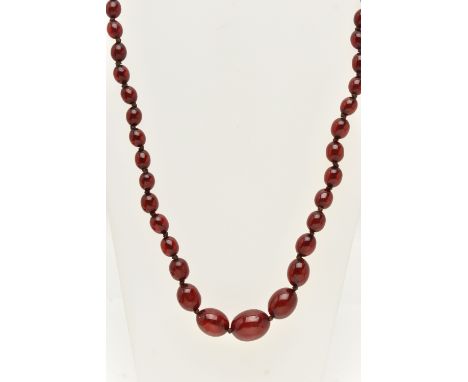 A BAKELITE CHERRY AMBER COLOUR NECKLACE, graduated oval beads forty-nine beads in total, largest measuring 19.8mm x 15.2mm, s