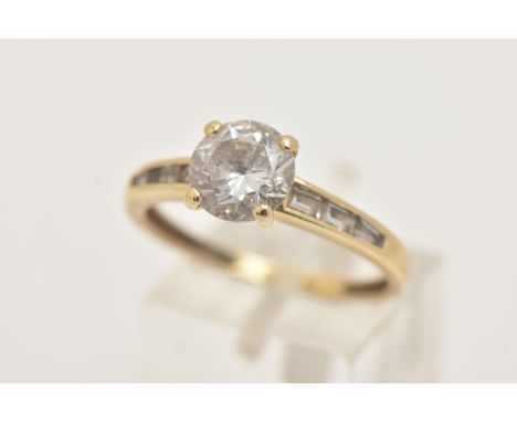 A 14CT GOLD CUBIC ZIRCONIA RING, set with a central circular cut colourless cubic zirconia, and baguette cut cubic zirconia s