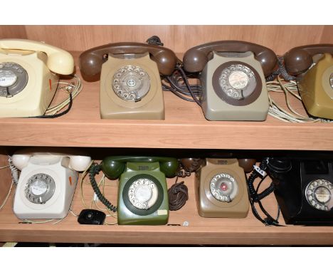 A GROUP OF EIGHT ROTARY DIAL VINTAGE TELEPHONES to include seven GEN 746 telephones in various shades of green, cream, and br