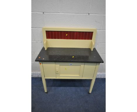 A 20TH CENTURY YELLOW PAINTED MARBLE TOP WASH STAND, the raised back with red tile inserts, and a single door, raised on squa