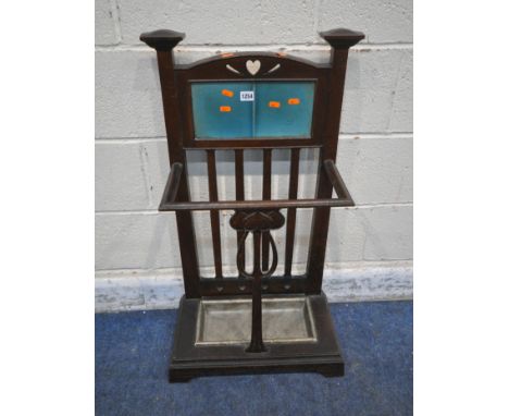 AN ART NOUVEAU CAST IRON UMBRELLA / STICK STAND, the arched back cradling two blue tiles, an arrangement of heart details all