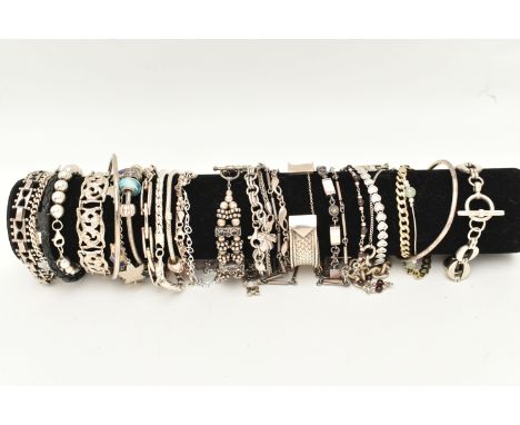 A BLACK SUEDE BRACELET DISPLAY PIECE WITH SILVER AND WHITE METAL BRACELETS, to include a silver flat curb link bracelet with 