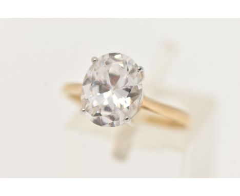 A 9CT GOLD CUBIC ZIRCONIA RING, designed with an oval cut colourless cubic zirconia in a four claw white metal setting, leadi