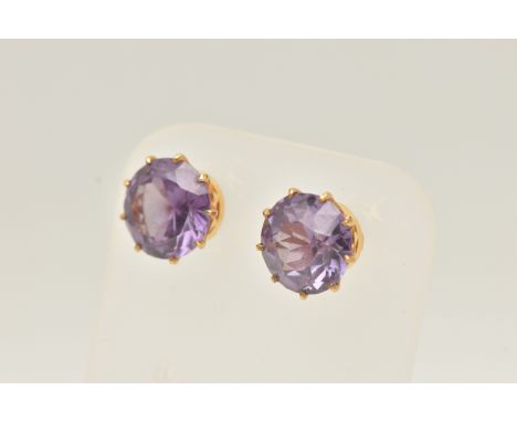 A PAIR OF YELLOW METAL GEM SET EARRINGS, each earring set with a circular cut synthetic colour change sapphire in a nine claw