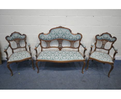 AN EDWARDIAN WALNUT THREE PIECE SUITE, with shaped foliate crests, splat backs, swept open armrests, raised on front cabriole