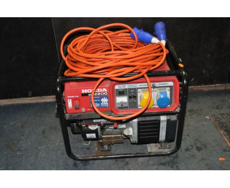 A HONDA EM2200 PETROL GENERATOR with 240v, 110v and 12v outlets and a 240v extension lead (engine pulls freely but hasn't bee
