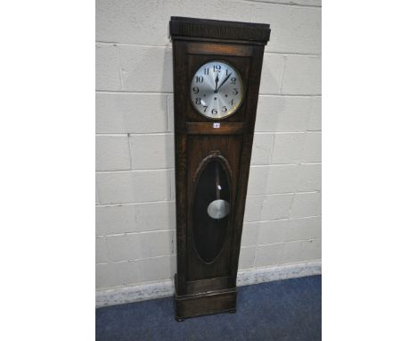 A 20TH CENTURY OAK LONGCASE CLOCK, the trunk door enclosing an 11 inch brass and silvered dial, depicting Arabic numerals, he