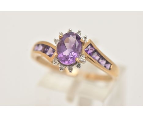A 9CT GOLD AMETHYST AND DIAMOND DRESS RING, set with a central oval cut amethyst, in a surround of single cut diamonds, cross