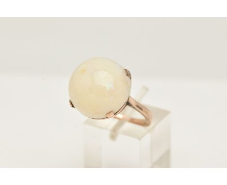 A YELLOW METAL OPAL SINGLE STONE RING, set with an opal cabochon, measuring approx 16.72 by 17.50mm, depth approx 9.05mm, fou