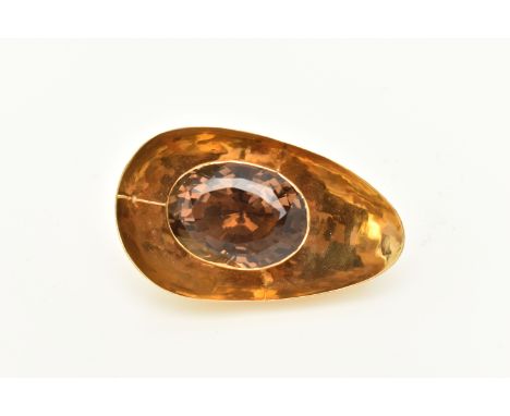 A 1970S SMOKEY QUARTZ PENDANT, the abstract design pendant set with an oval shape mixed cut smokey quartz, measuring approxim