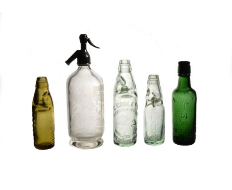 A collection of vintage glass bottles, including a Caley's soda siphon, five codd bottles, including C. Cobley's, Groves &amp