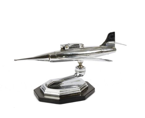 A 1950's chrome desk cigarette lighter, modelled as a jet aeroplane, mounted on a black bakelite base, 23 cm long