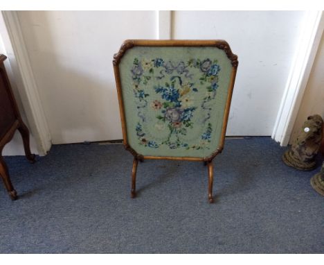 A 20th Century walnut tilt-top fire screen table, glazed top revealing floral tapestry, 64 cm wide x 53.5 cm deep x 54 cm hig