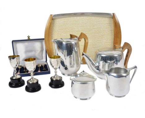 A four piece Picquot tea service, with matching tray, together with three Goldsmiths &amp; Silversmiths Co Ltd silver trophie