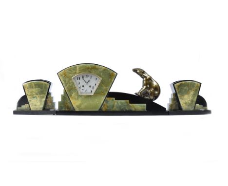 A three piece Art Deco onyx garniture clock set, surmounted with a polar bear, 27 cm high (3)