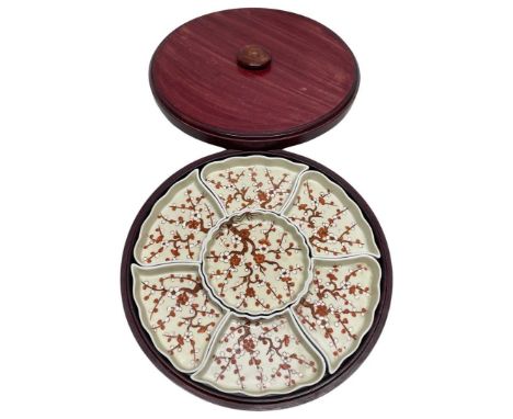 Modern Oriental lazy susan of circular form with lift off lid and fitted with seven ceramic compartments33cm diamQty: 1