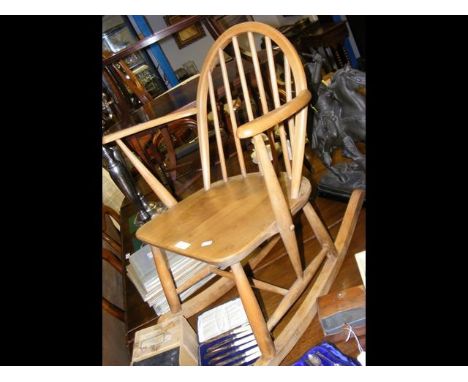 A child's antique Ercol stick back rocking chair 