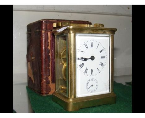 A brass cased carriage clock with alarm - 11.5cm high - with leather carrying case CONDITION REPORT3" glassworksno key