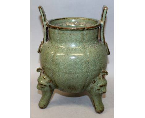 A CHINESE CELADON GLAZED LONGQUAN STYLE CERAMIC TRIPOD CENSER, applied with a mottled glaze, 10in high to top of handles.