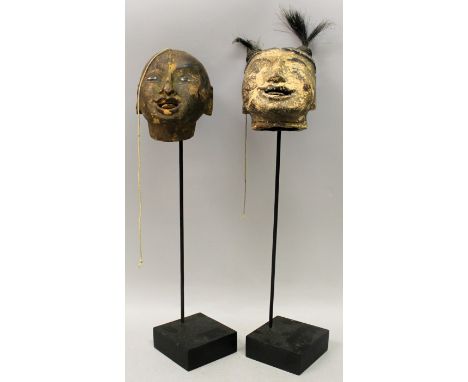 AN UNUSUAL PAIR OF 19TH CENTURY CHINESE LACQUERED WOOD PUPPET HEADS, mounted on stands, 17.5in & 17in high overall, the heads