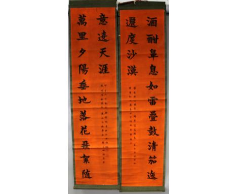 A PAIR OF CHINESE HANGING SCROLL PICTURES, each decorated with calligraphy reserved on an orange-red ground, each picture its