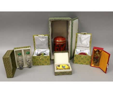 SIX FABRIC CASED BOXES, containing a cloisonne box, three enamel boxes and three interior painted snuff bottles. (6)