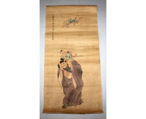 A CHINESE PAPER SCROLL PICTURE, decorated with an Immortal bearing a child on his shoulders, 36in x 17in.