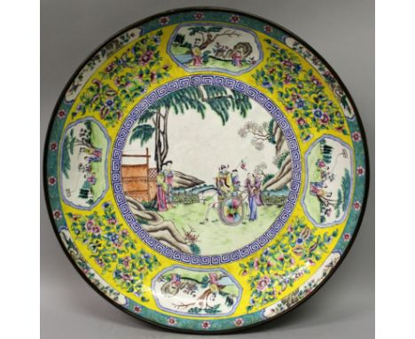 A LARGE 19TH CENTURY CHINESE CANTON ENAMEL DISH, decorated to its centre with a garden figural scene within a border of vigne