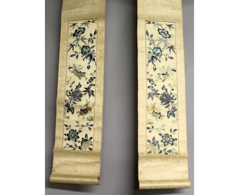 A PAIR OF 20TH CENTURY CHINESE EMBROIDERED SILK HANGING SCROLL PICTURES, each decorated with swimming fish and foliage, each 